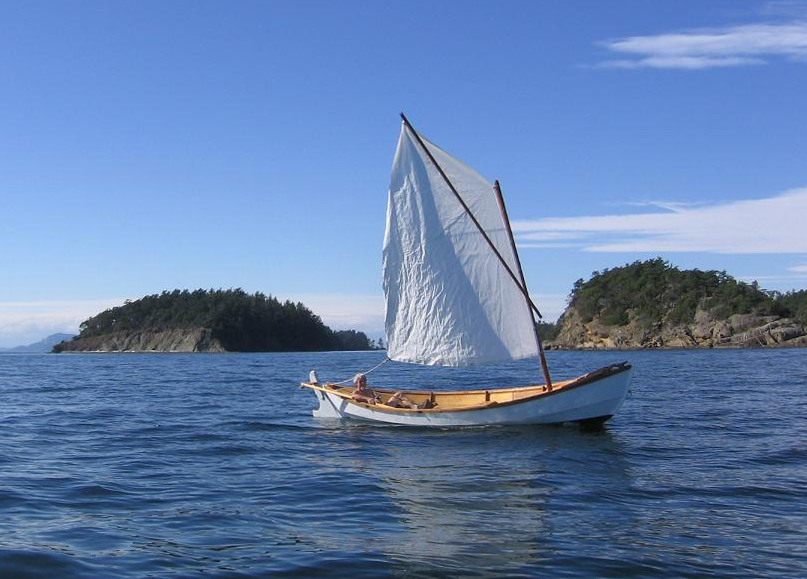 The loose-footed sprit sail makes sailing about as simple as it gets. Light summer breezes make for unhurried passages between islands.
