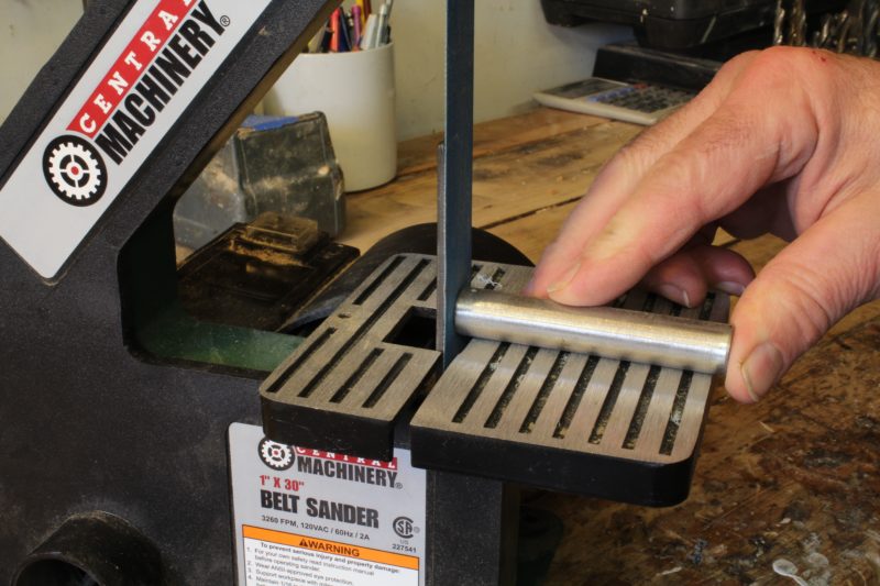 The backing plate keeps the belt straight for working flat surfaces.