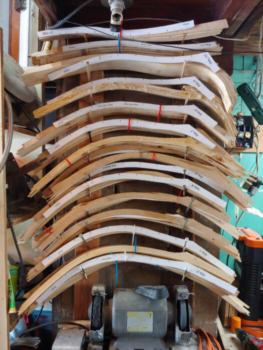 Wooden boat frames racked together.